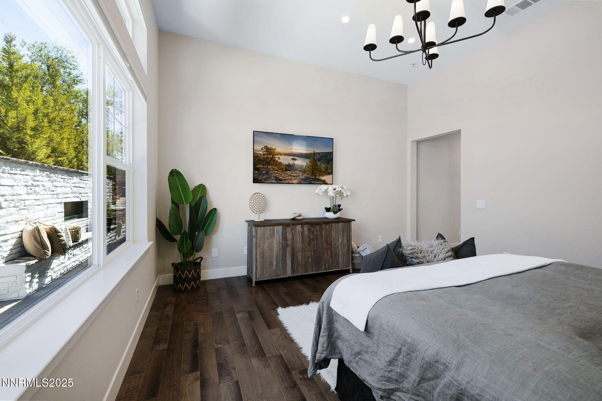 709 West Pleasant Oak Trail Reno, NV 89511 - Photo 21 of 44 a bedroom with a bed a flat screen tv and a couch