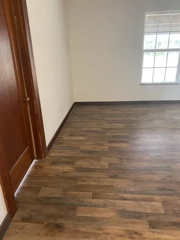 a view of a room with wooden floor