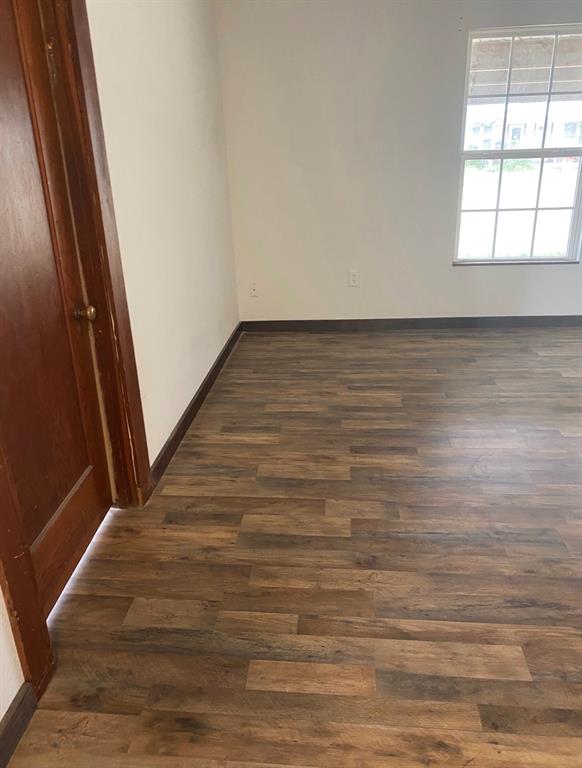 352 Southwest Ave A Hamlin, TX 79520 - Photo 2 of 13 a view of a room with wooden floor and white walls