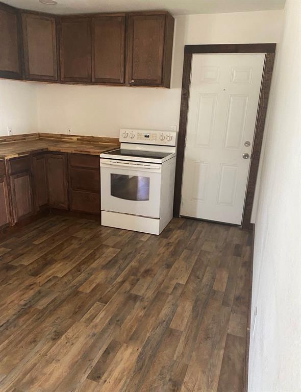 352 Southwest Ave A Hamlin, TX 79520 - Photo 5 of 13 a kitchen with a stove top oven sink and cabinets