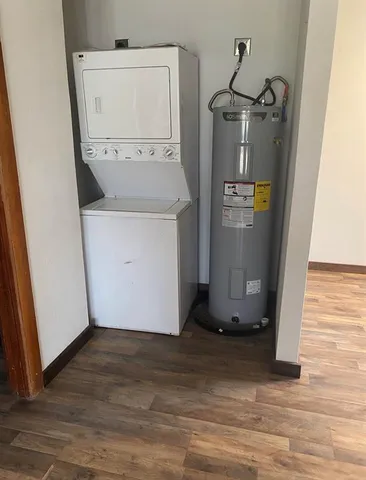 a utility room with wooden floor washer and dryer