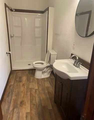 a bathroom with a sink toilet and shower