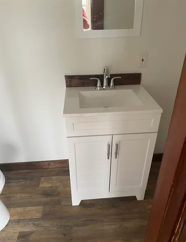 a bathroom with a sink and a mirror