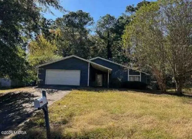 a house with trees in the background