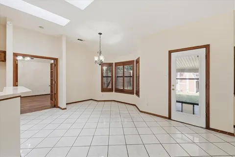 a view of a kitchen with a sink and an entryway