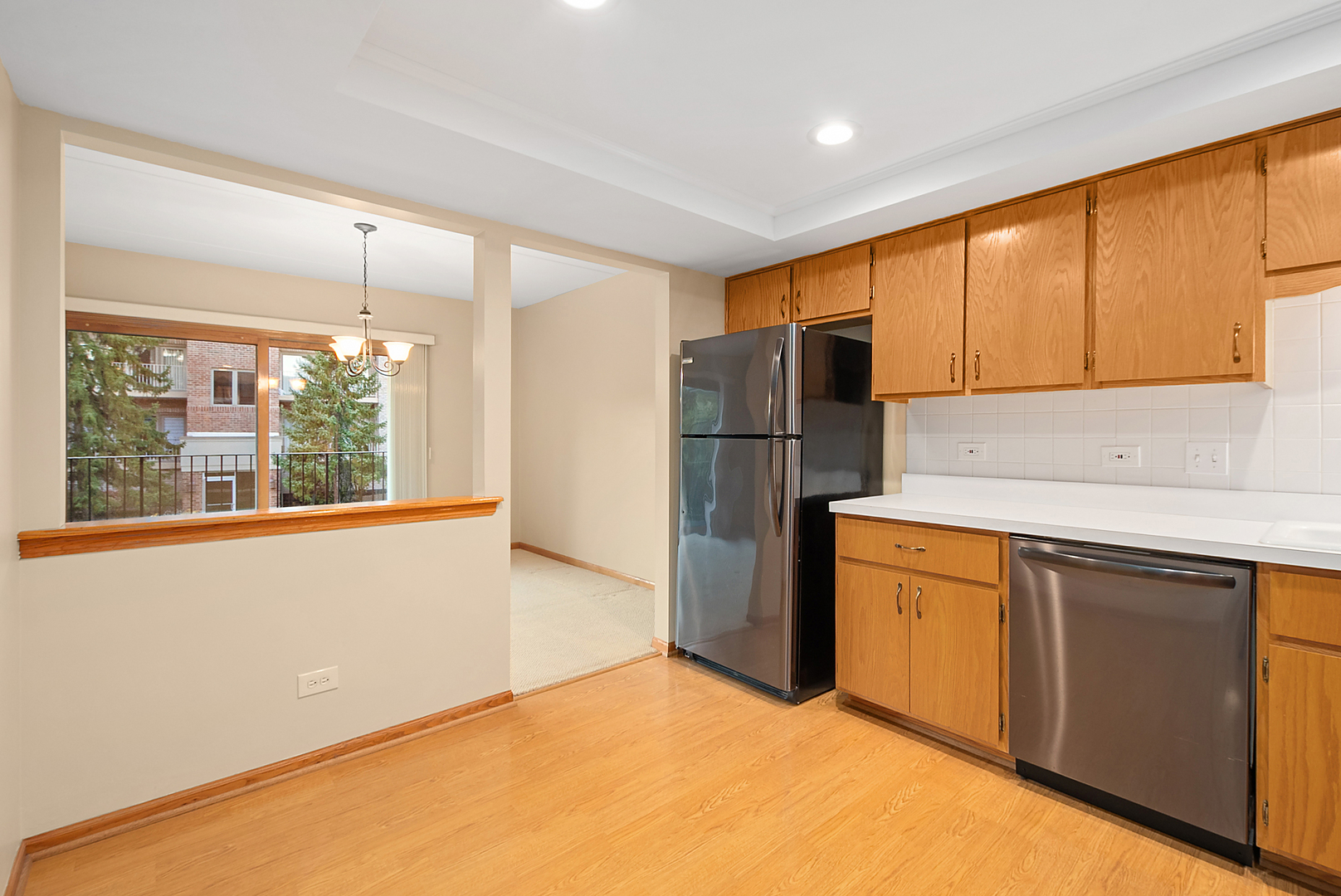 7811 West 157th Street, Unit 1N Orland Park, IL 60462 - Photo 11 of 18 a kitchen with refrigerator and window