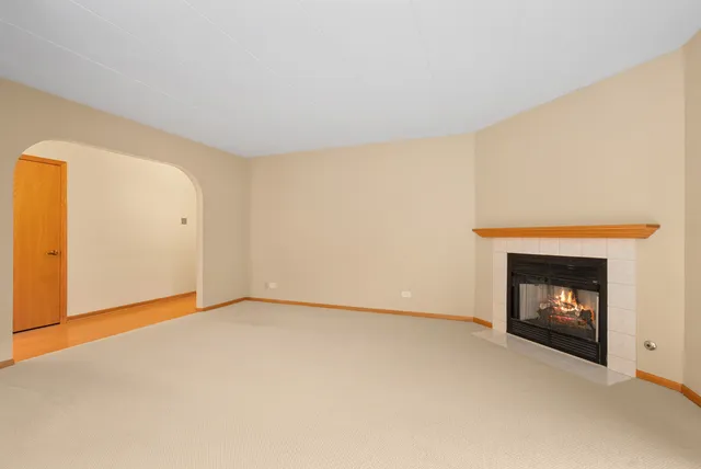a view of an empty room with a fireplace