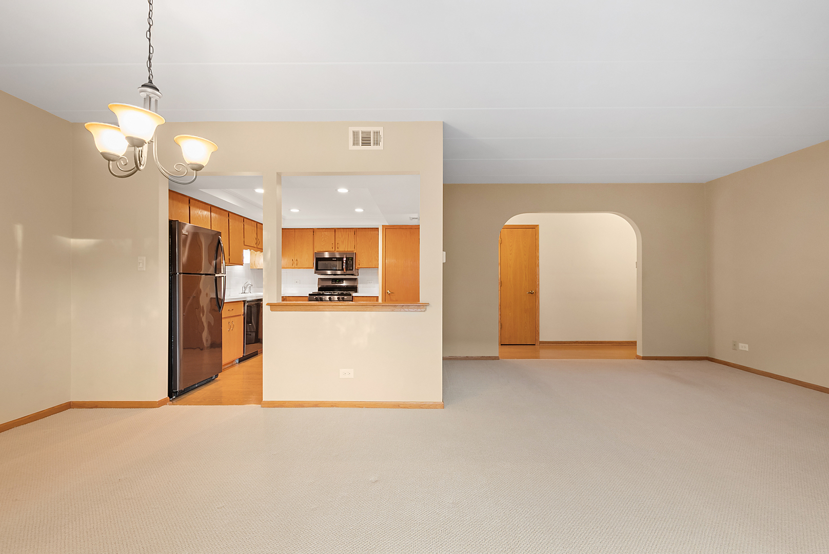 7811 West 157th Street, Unit 1N Orland Park, IL 60462 - Photo 8 of 18 a view of a kitchen with a refrigerator and a sink