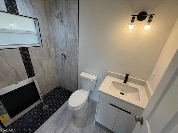a white toilet sitting next to a bathroom sink