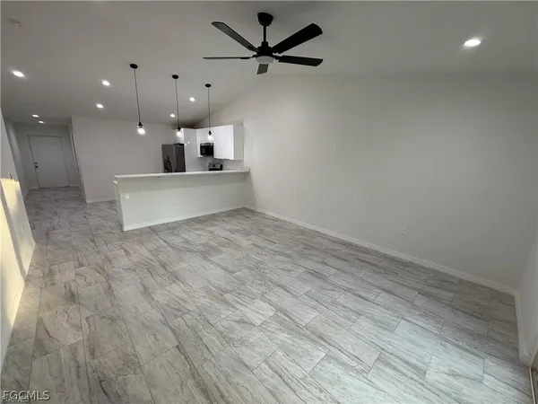 a view of a kitchen with a sink and a refrigerator