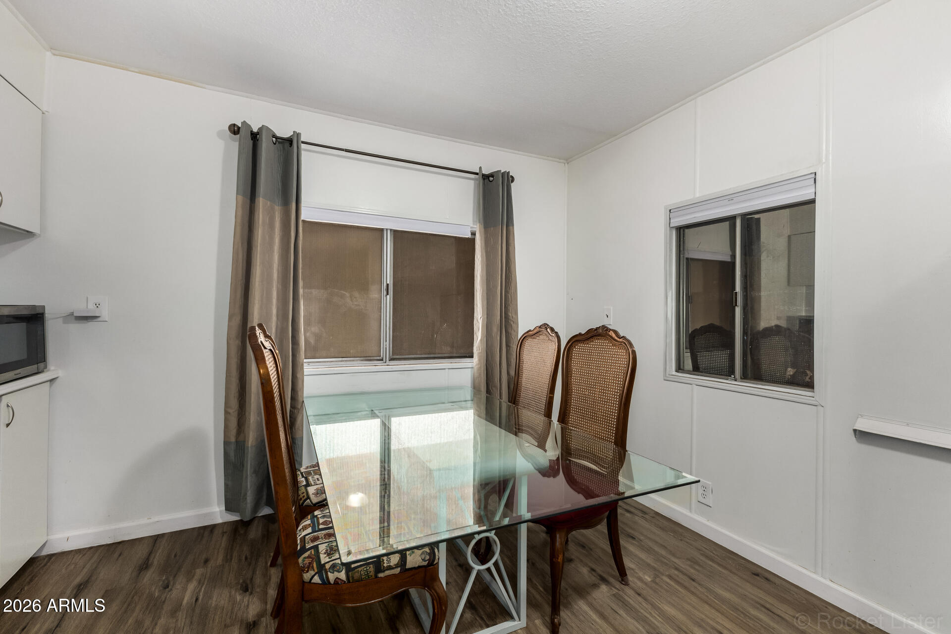 5201 West Camelback Road, Unit G264 Phoenix, AZ 85031 - Photo 4 of 16 a dining room with furniture and wooden floor