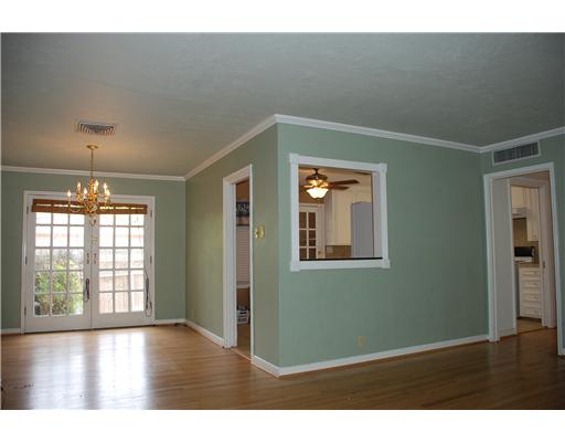 626 Pasadena Place Corpus Christi, TX 78411 - Photo 2 of 10 a view of an empty room with wooden floor and a window