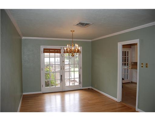 626 Pasadena Place Corpus Christi, TX 78411 - Photo 4 of 10 a big room with wooden floor chandelier and windows