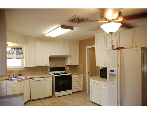 626 Pasadena Place Corpus Christi, TX 78411 - Photo 6 of 10 a kitchen with stainless steel appliances a stove a sink and a refrigerator