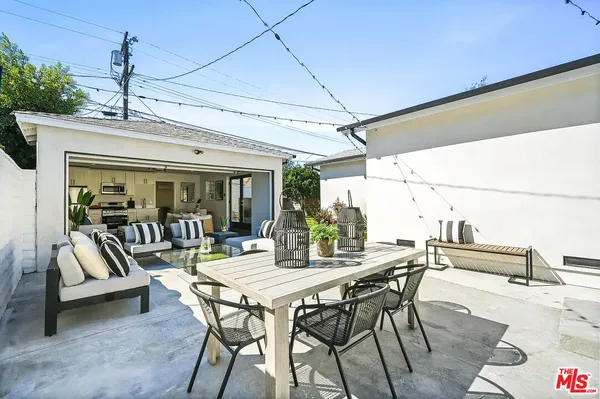 a view of a patio with a dining table and chairs