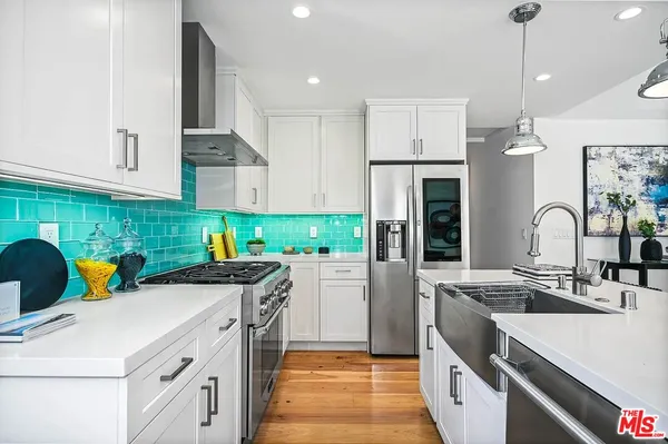 a kitchen that has a sink and a stove in it