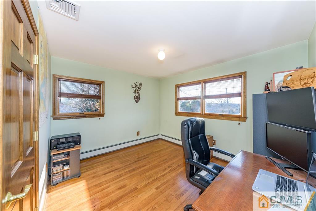 204 Amboy Road Old Bridge, NJ 07747 - Photo 14 of 25 a room with furniture and a flat screen tv