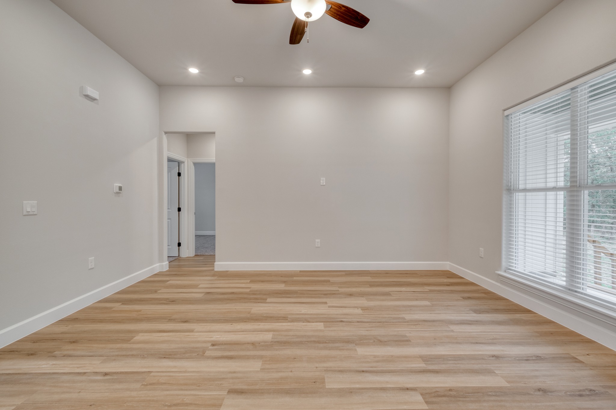 116 Pine Point Cove Elgin, TX 78621 - Photo 6 of 27 Spacious room featuring wood-finish flooring, recessed lighting, and a ceiling fan