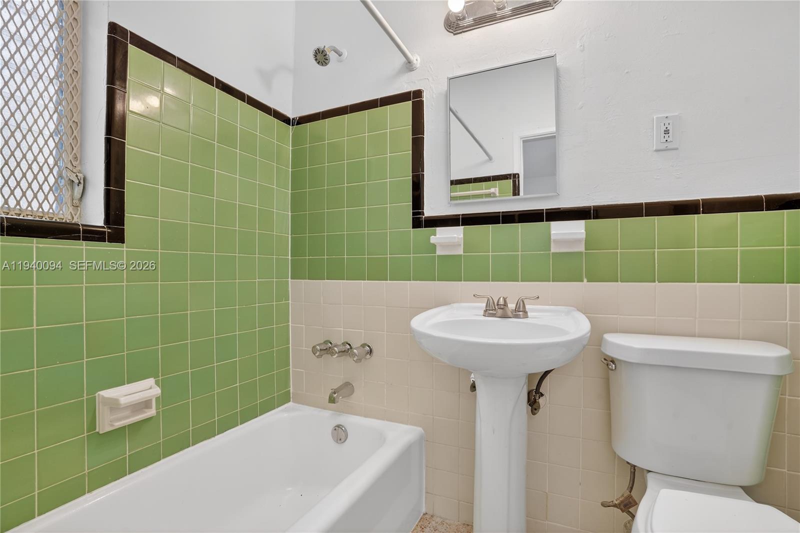 140 Southwest 30th Court, Unit 130 Miami, FL 33135 - Photo 13 of 18 a bathroom with a sink mirror toilet and shower