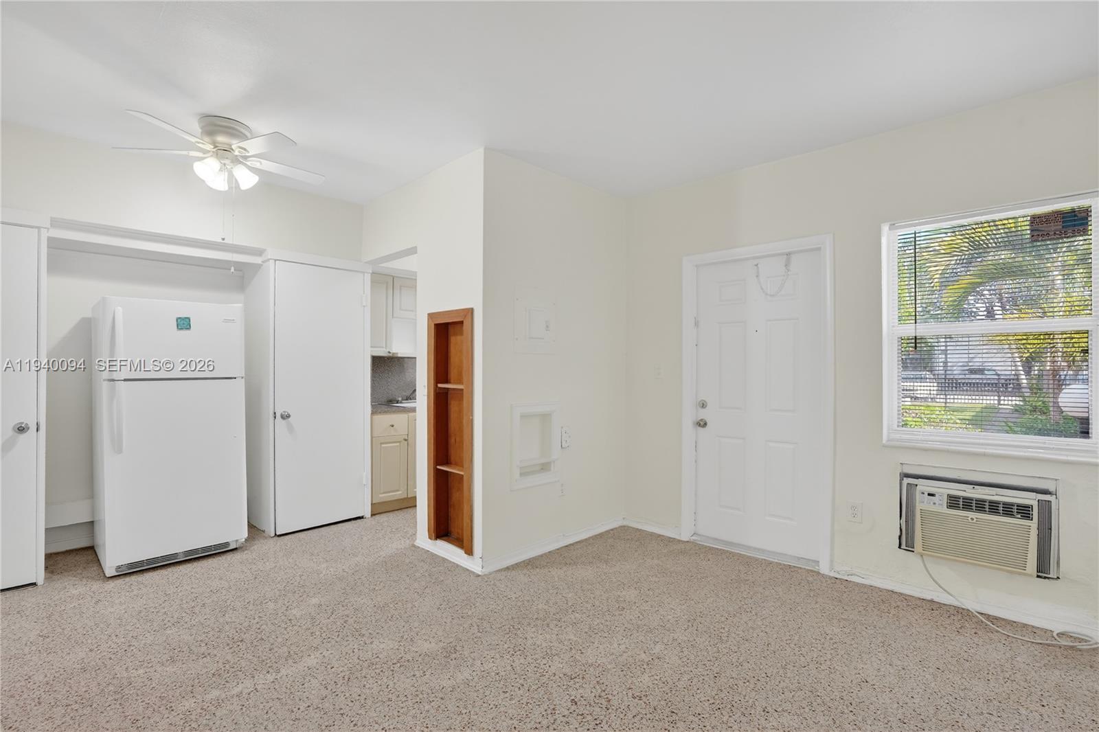 140 Southwest 30th Court, Unit 130 Miami, FL 33135 - Photo 7 of 18 an empty room with windows and cabinet