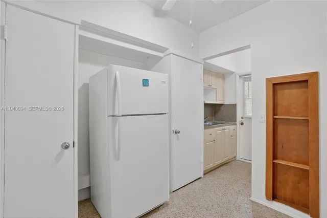 a kitchen with stainless steel appliances a refrigerator and a cabinets