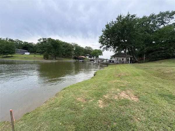 a view of a lake with houses in the back