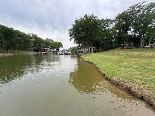 a view of a lake with houses in the back