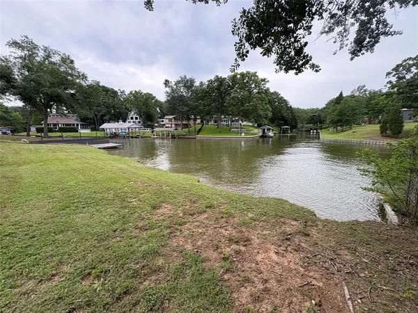 a view of a lake with houses in the back