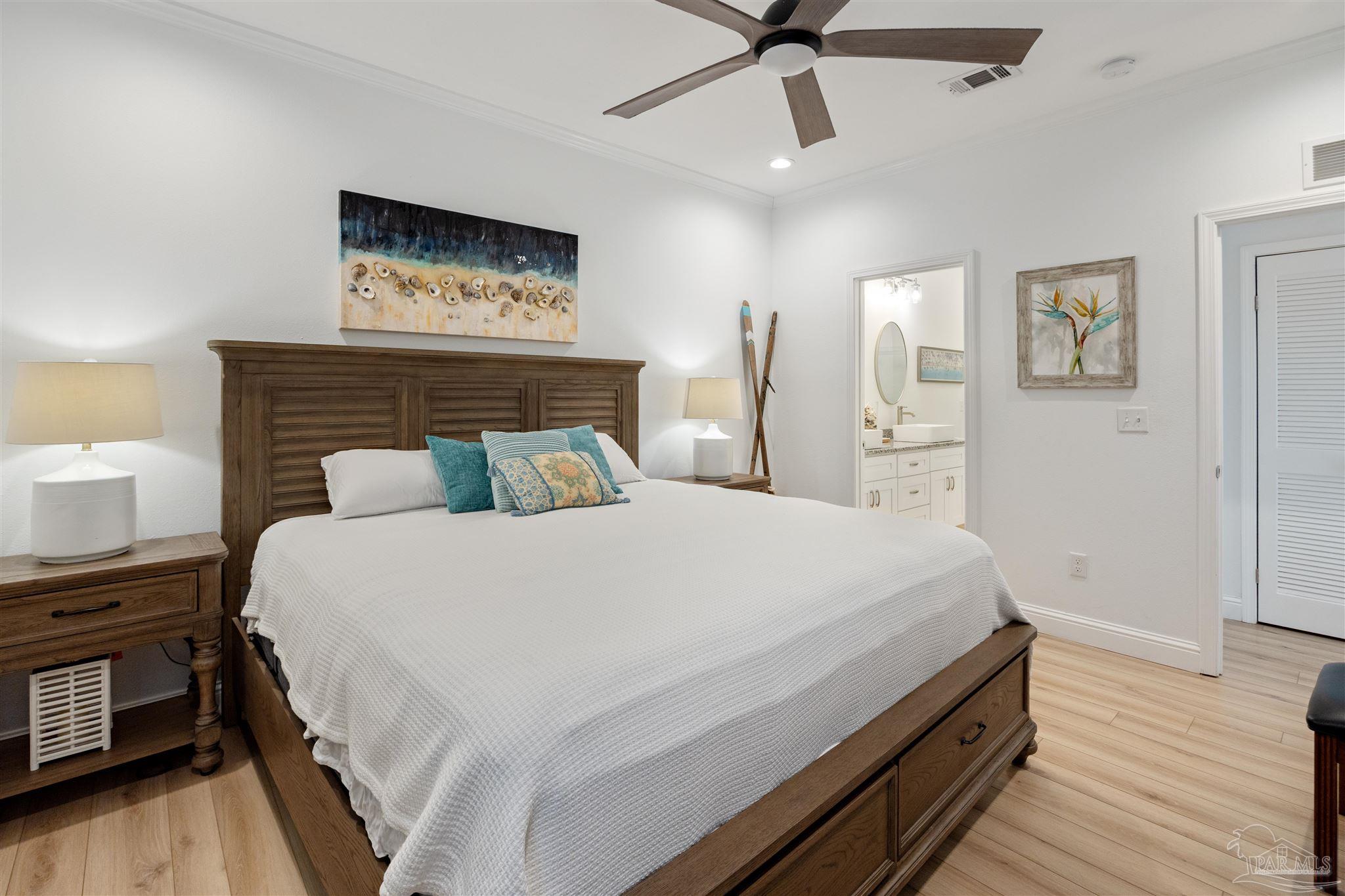 17290 Perdido Key Drive, Unit B2 Pensacola, FL 32507 - Photo 20 of 54 a bedroom with a bed and wooden floor