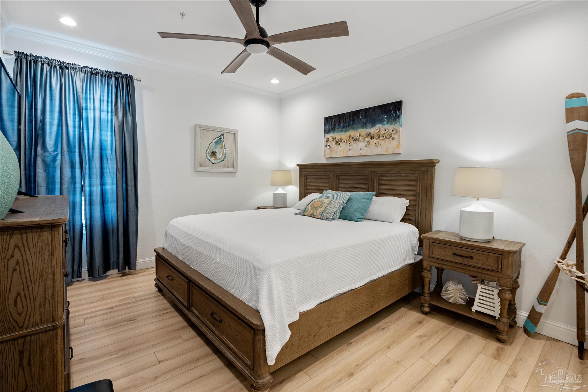 17290 Perdido Key Drive, Unit B2 Pensacola, FL 32507 - Photo 21 of 54 a bedroom with a bed and wooden floor