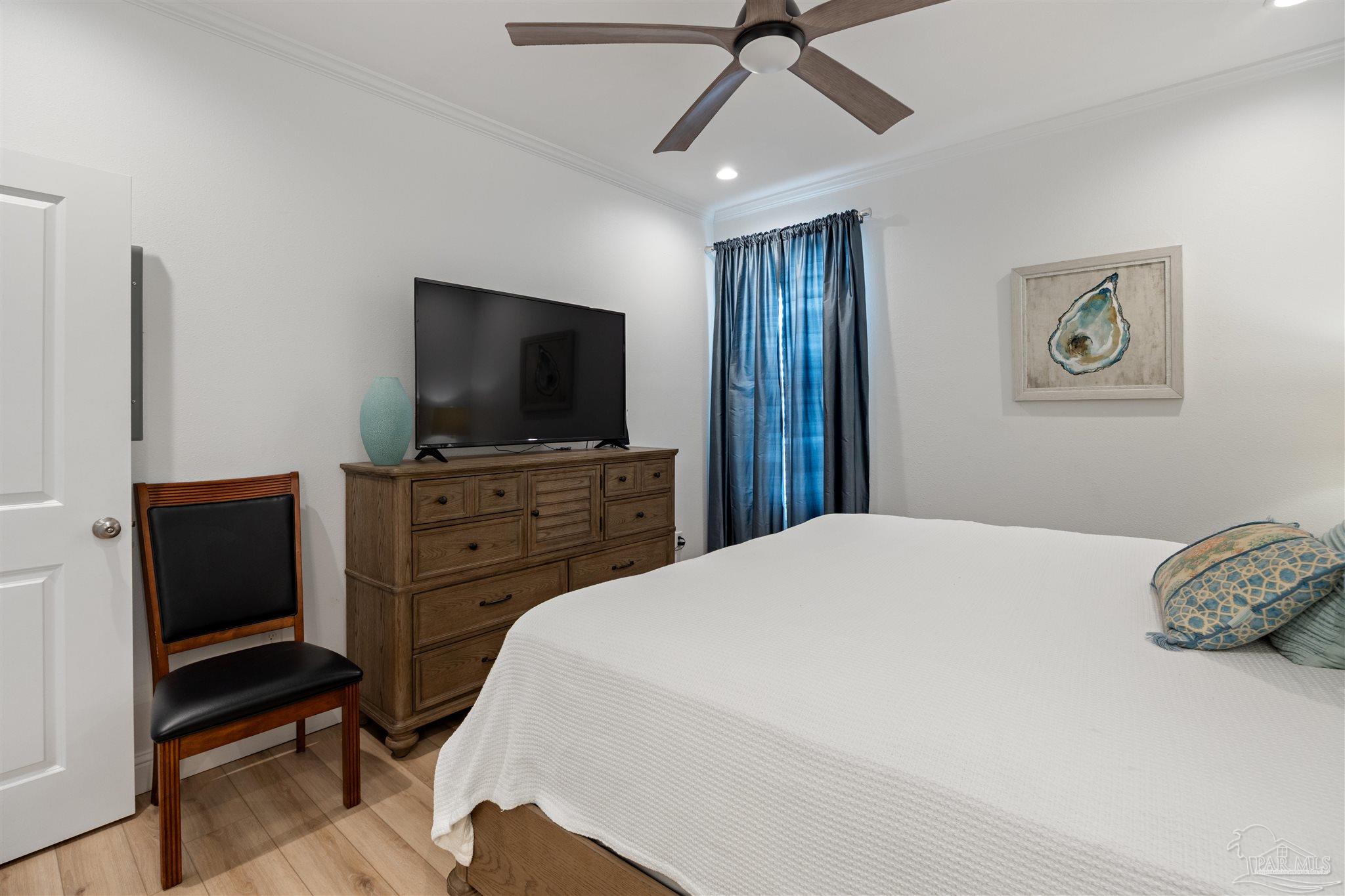 17290 Perdido Key Drive, Unit B2 Pensacola, FL 32507 - Photo 22 of 54 a bedroom with a bed and a flat screen tv