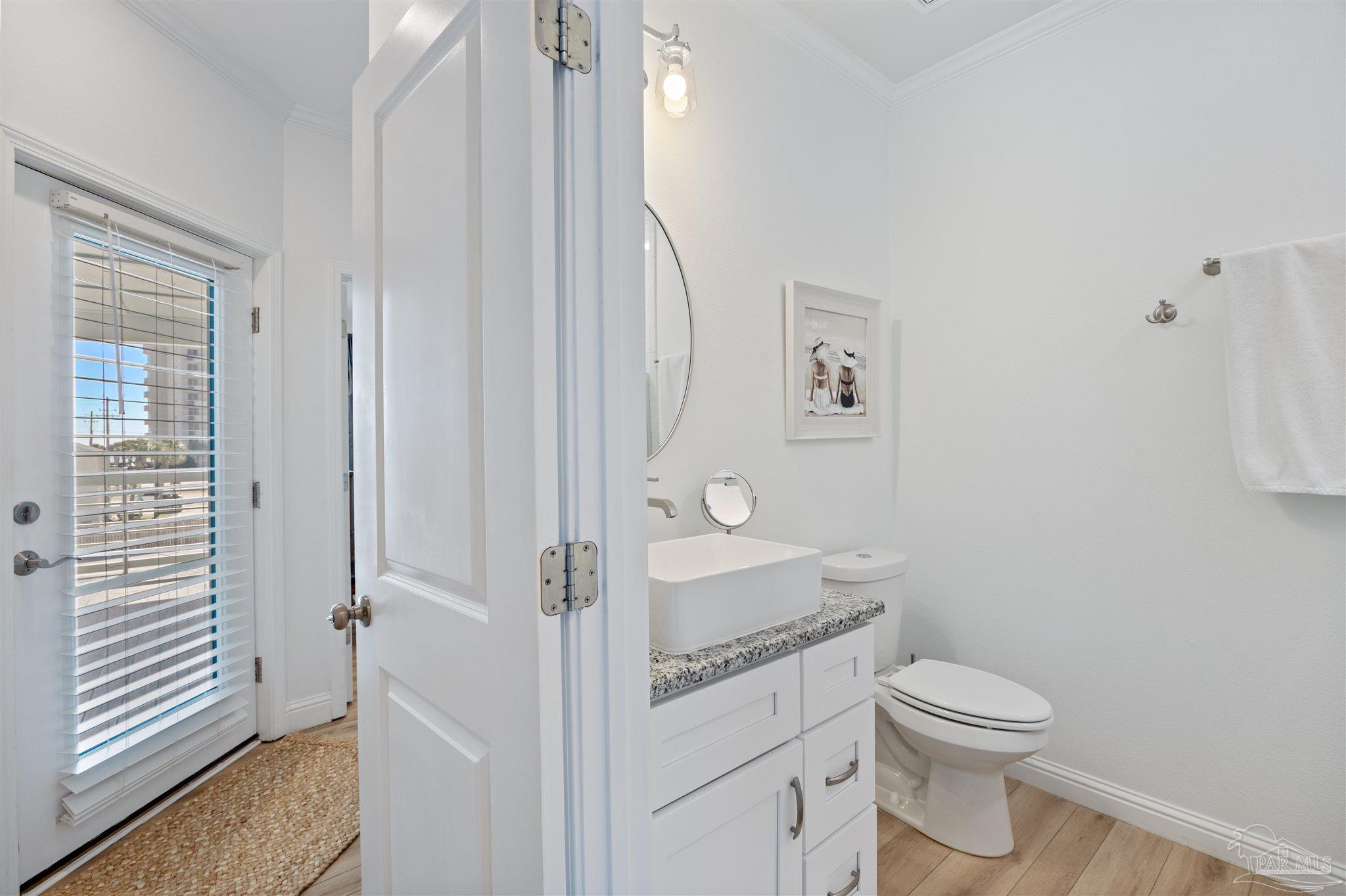17290 Perdido Key Drive, Unit B2 Pensacola, FL 32507 - Photo 28 of 54 a bathroom with a granite countertop toilet sink and a mirror
