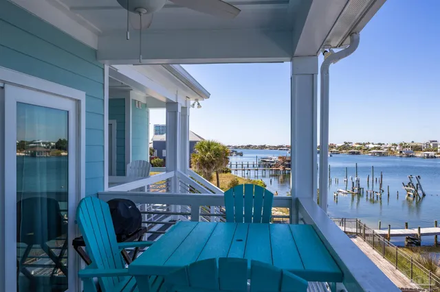 a view of a balcony dining table and chairs