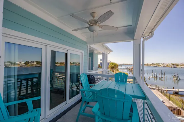 a view of a house with swimming pool and sitting area
