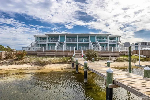 a roof deck with a barbeque and wooden floor