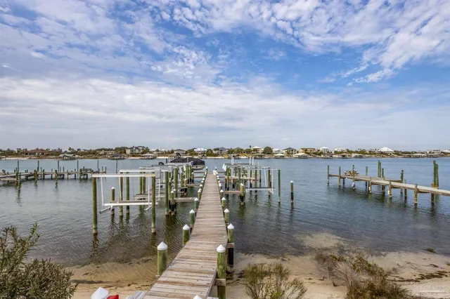 a view of a lake with houses in the back