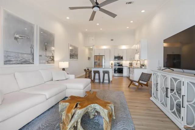 a kitchen with granite countertop white cabinets and stainless steel appliances