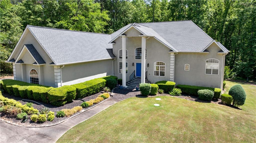 915 Magnolia Way Hampton, GA 30228 - Photo 1 of 68 a front view of a house with a yard and potted plants