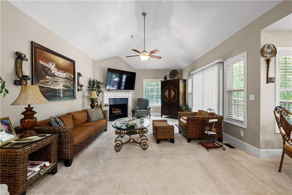 915 Magnolia Way Hampton, GA 30228 - Photo 24 of 68 a living room with furniture a fireplace and a flat screen tv