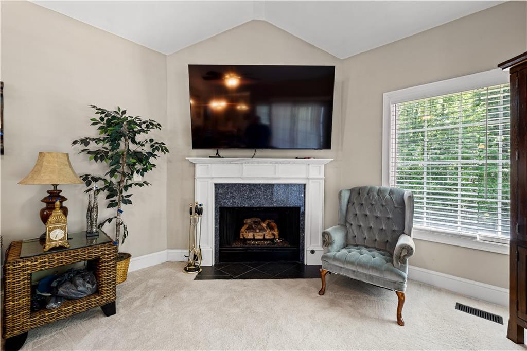 915 Magnolia Way Hampton, GA 30228 - Photo 25 of 68 a living room with furniture and a fireplace