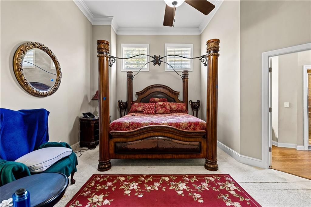 915 Magnolia Way Hampton, GA 30228 - Photo 27 of 68 a bedroom with a bed and a chandelier