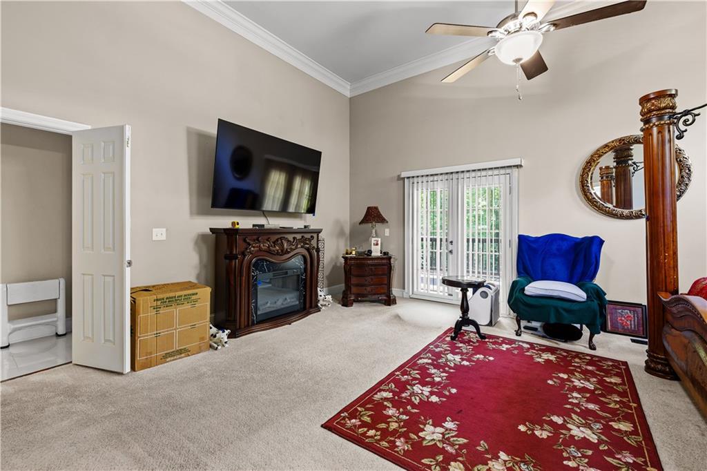 915 Magnolia Way Hampton, GA 30228 - Photo 28 of 68 a living room with furniture a flat screen tv and a fireplace