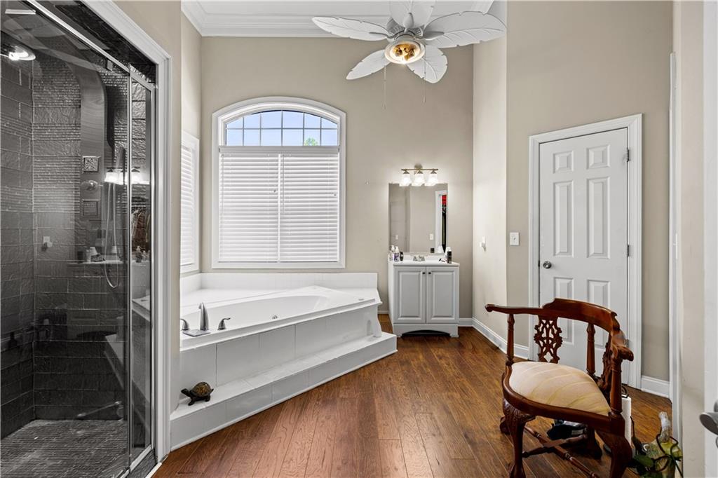 915 Magnolia Way Hampton, GA 30228 - Photo 31 of 68 a spacious bedroom with a bed and a chandelier