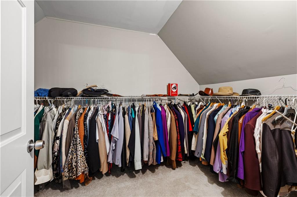 915 Magnolia Way Hampton, GA 30228 - Photo 32 of 68 a view of walk in closet with clothes