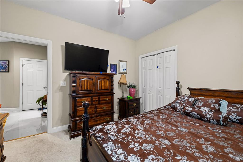 915 Magnolia Way Hampton, GA 30228 - Photo 35 of 68 a bedroom with a bed and a flat screen tv