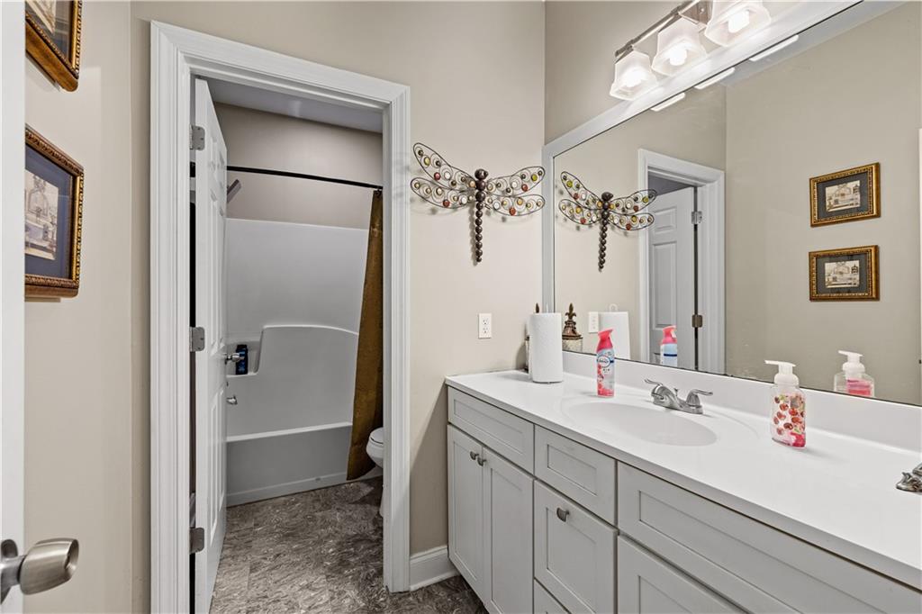 915 Magnolia Way Hampton, GA 30228 - Photo 37 of 68 a bathroom with a double vanity sink mirror and shower