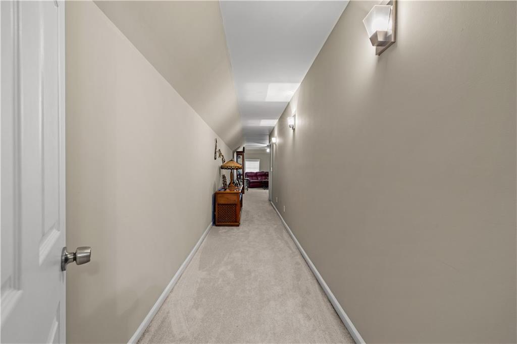 915 Magnolia Way Hampton, GA 30228 - Photo 42 of 68 a view of a hallway with wooden floor
