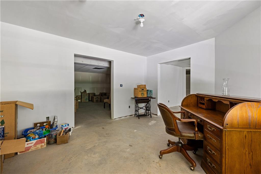 915 Magnolia Way Hampton, GA 30228 - Photo 52 of 68 a view of a workspace with furniture and a livingroom