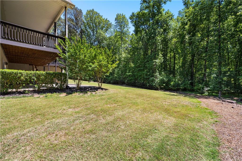 915 Magnolia Way Hampton, GA 30228 - Photo 62 of 68 a view of a swimming pool with an outdoor seating and a yard