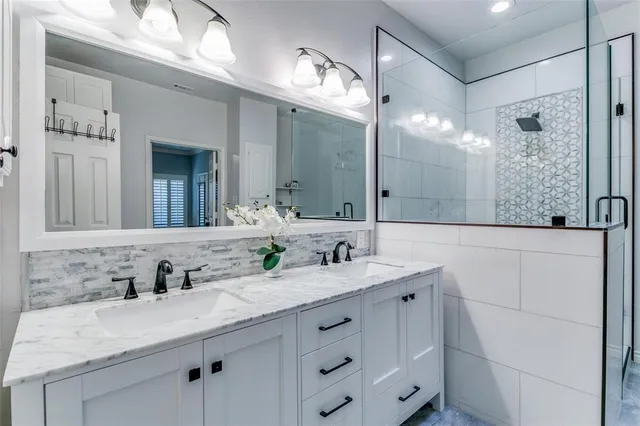 a bathroom with a granite countertop sink mirror and double